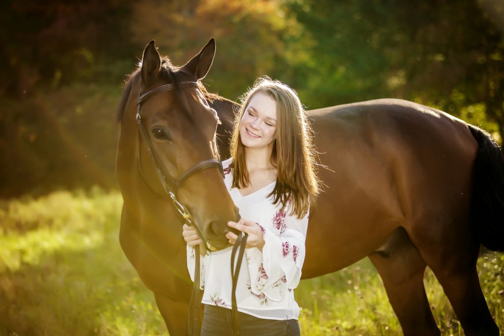 hs senior girl posing with her horse in a field for south shore ma photographer