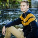 : Senior boy in colorful sweater in golden light, South Shore MA senior wardrobe example