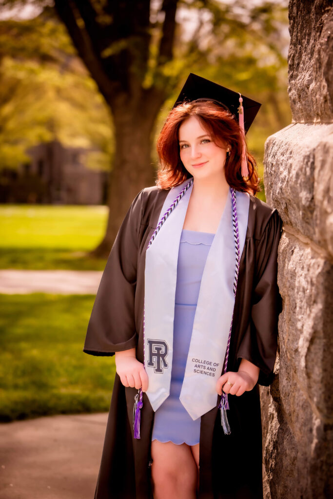 college senior girl posing on campus for graduation portraits in south shore ma