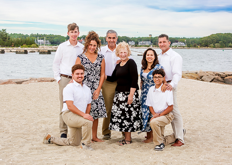 Family photo session on the beach wearing slight floral patterns