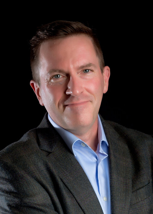 Headshot of a businessman in a gray suit