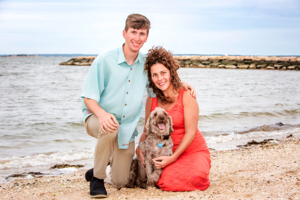 Candid, laughing family moment with a pet dog, Massachusetts family photographer