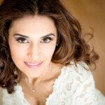 woman looking up at camera, smiling.